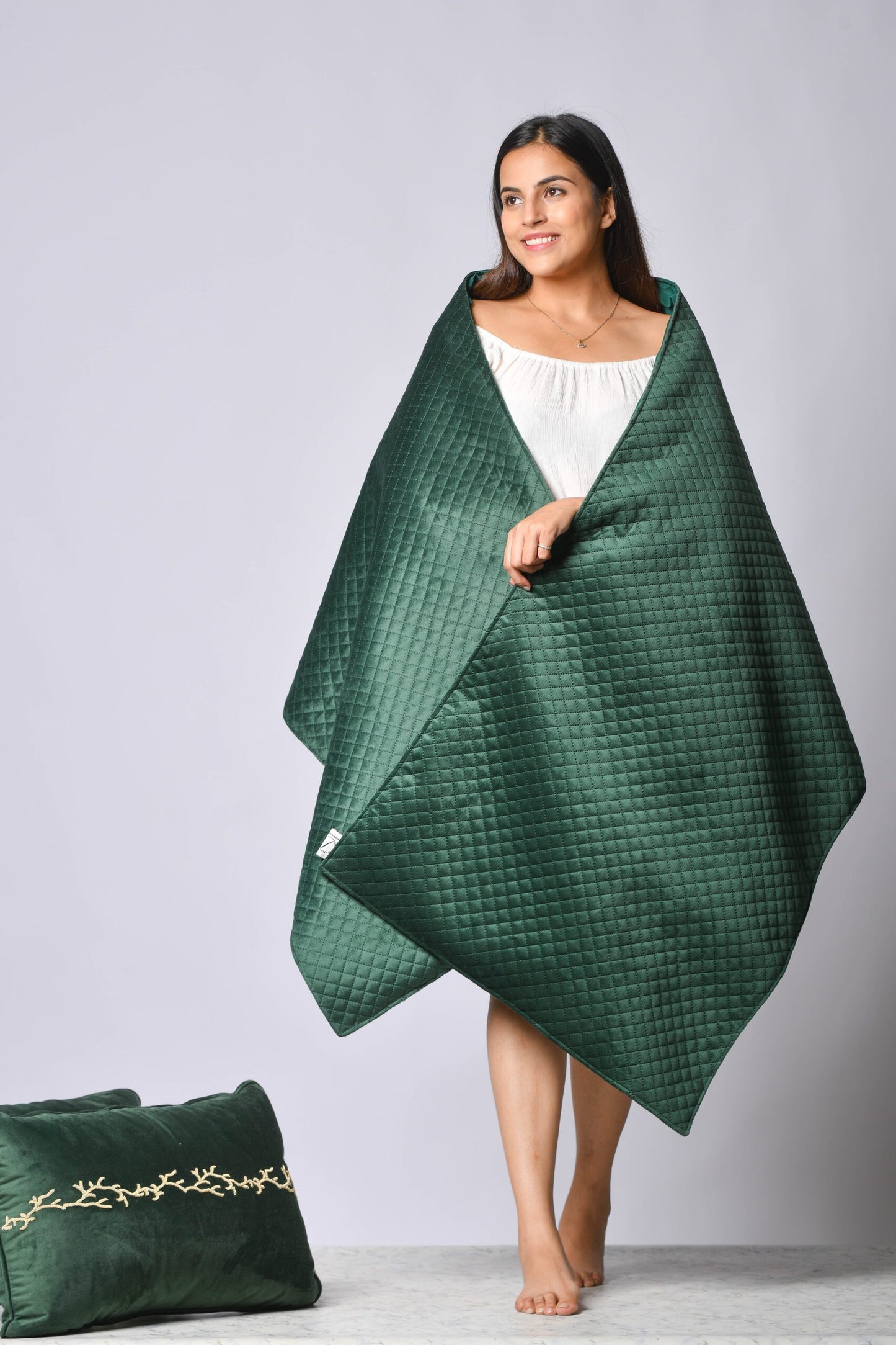 Photoshoot with model holding velevet material.